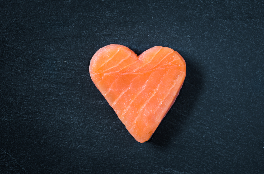 salmon in the shape of a heart to represent fatty fish for heart health according to vascular surgeons at michigan vascular center
