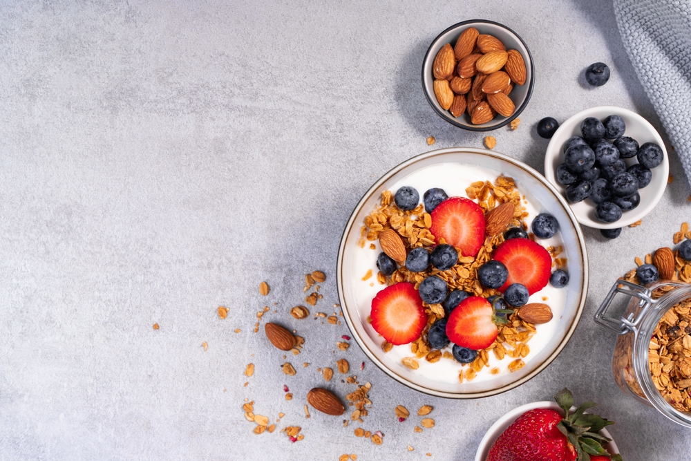 A yogurt parfait with granola and a variety of berries