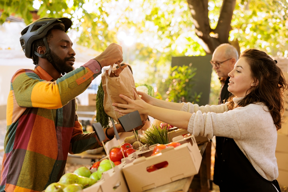 A man buying produce at a farmers market