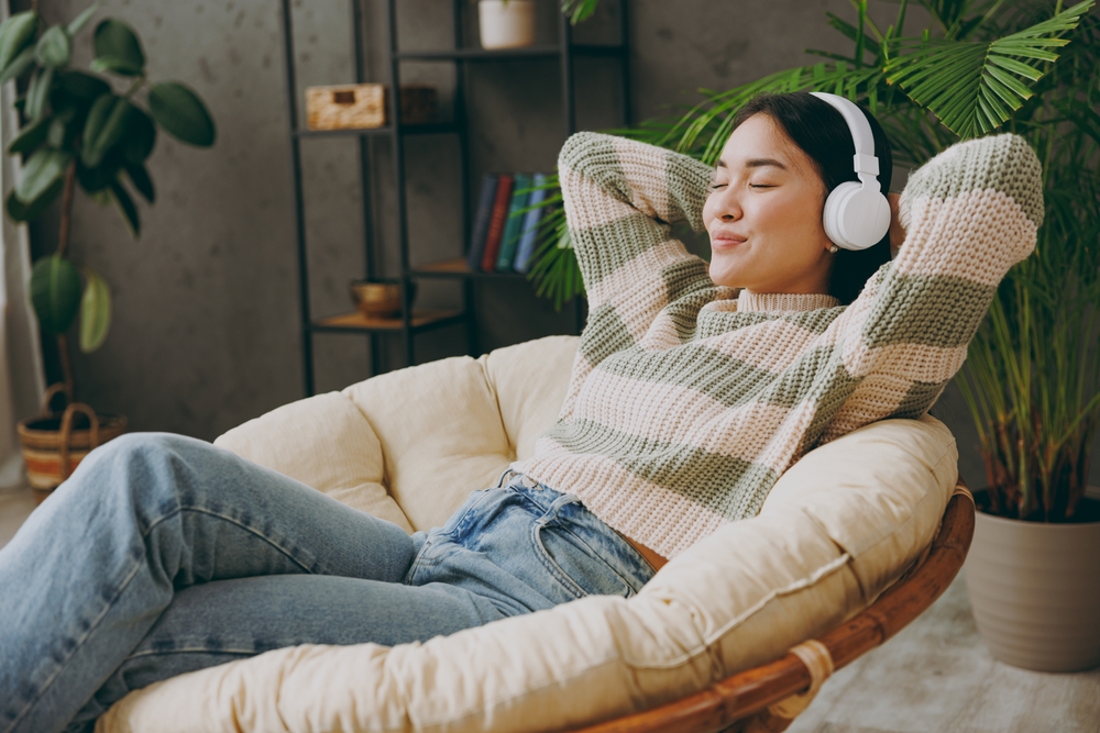 A woman relaxing listening to music.