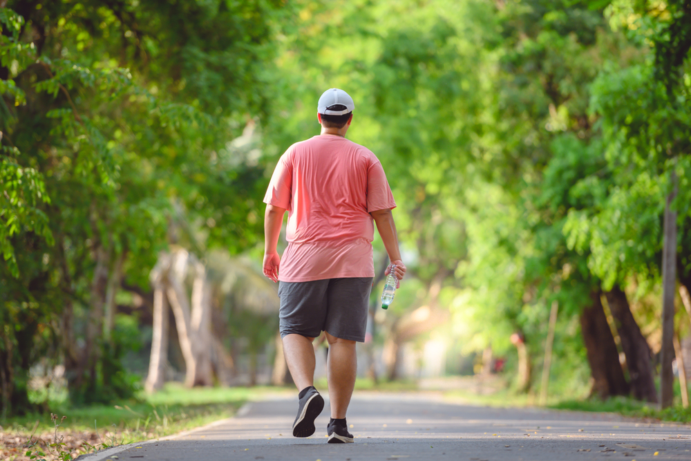 An overweight man on a walk