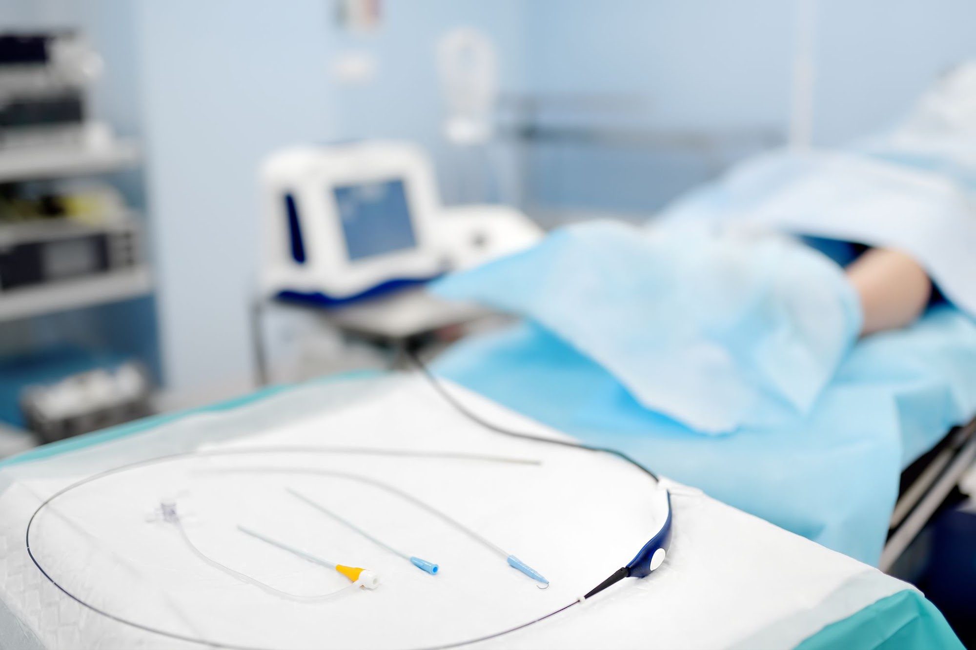Catheter and guidewire laid out on a sterile drape in a vascular procedure room